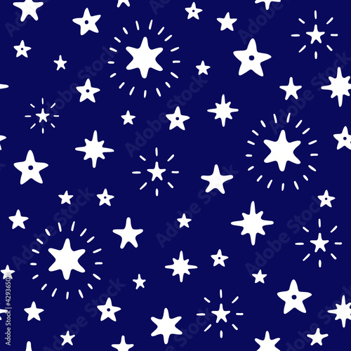 Doodle starry night sky vector seamless pattern. White silhouettes on a dark blue background. Hand Drawn endless magic print with stars.