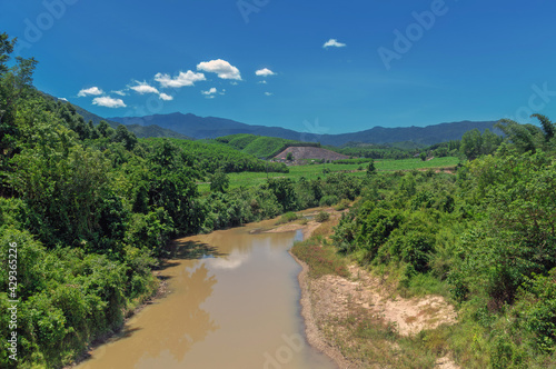 river among the hills covered with tropical forest