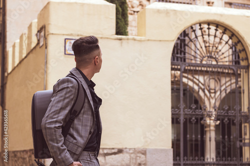 young businessman looking at a building