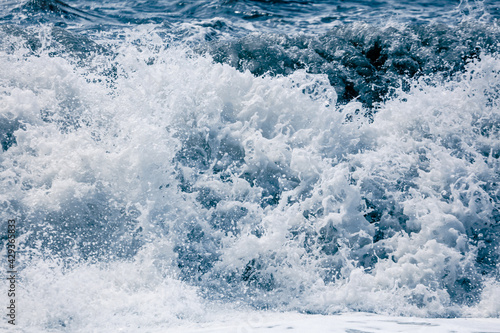 Splashing big waves on the seashore. © schankz