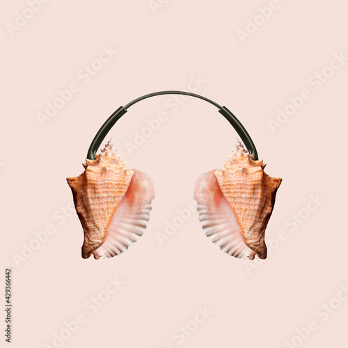 Contemporary art collage, modern design. Summer mood. Headphones made of shells on pastel brown