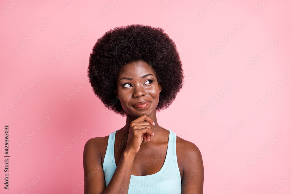 Portrait of optimistic brunette curly lady look empty space wear blue top isolated on pastel pink color background Portrait of optimistic brunette curly lady look empty space wear blue top isolated on pastel pink color background