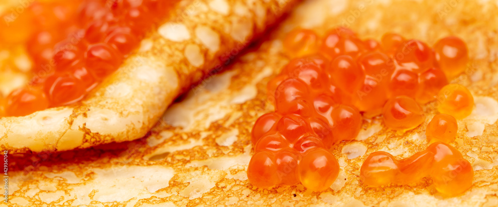 Pancake with red caviar as a background. Pancake with red caviar as a background.