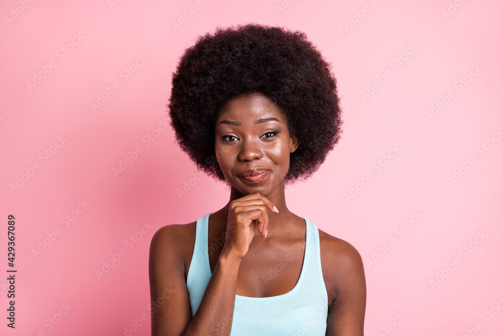 Portrait of optimistic brunette curly lady hand chin wear blue top isolated on pink color background Portrait of optimistic brunette curly lady hand chin wear blue top isolated on pink color background
