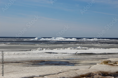 Ice blocks on a bay shoal on a sunny spring day