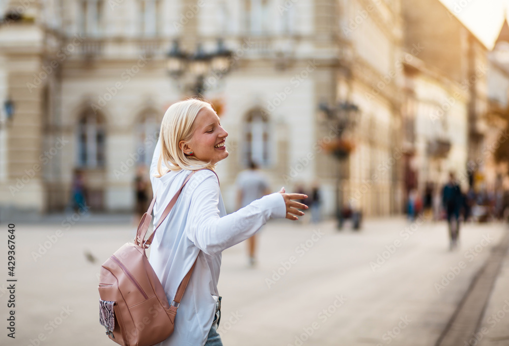 Happy woman with outstretched arms on the street. Happy woman with outstretched arms on the street.