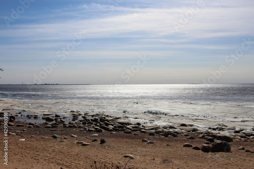 View of the bay and the ice floes near the shore on a sunny spring day  © Elena