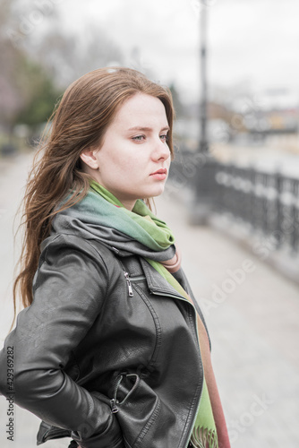 Portrait of a young girl who poses while walking in cloudy weather © Павел Костенко