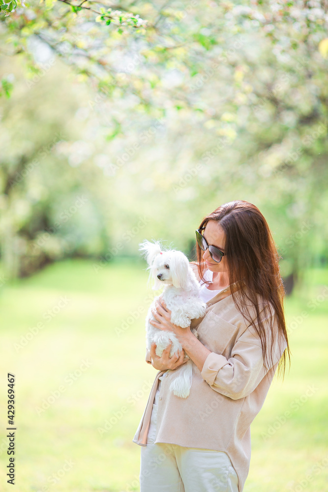 Woman playing and hugging puppy in the park Woman playing and hugging puppy in the park