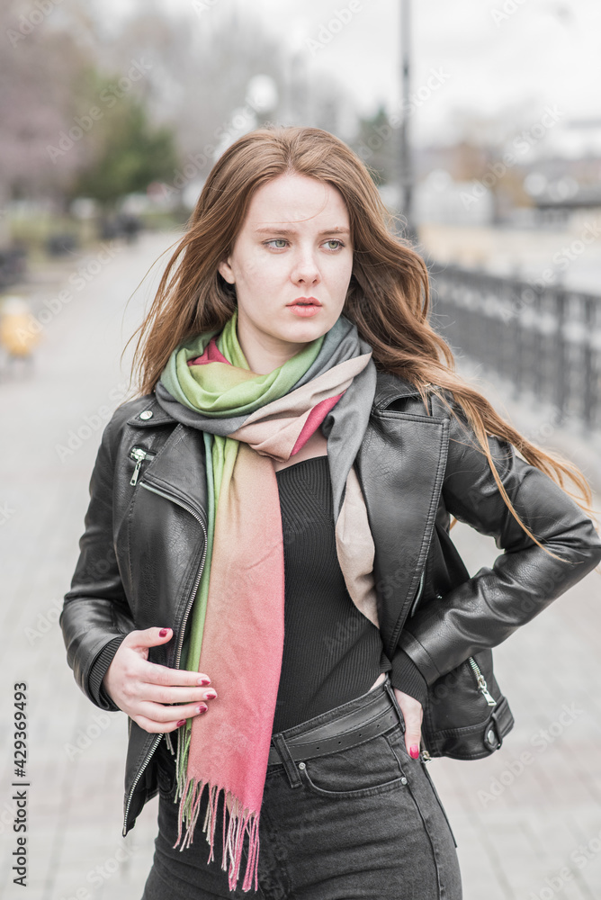 Portrait of a young girl who poses while walking in cloudy weather Portrait of a young girl who poses while walking in cloudy weather