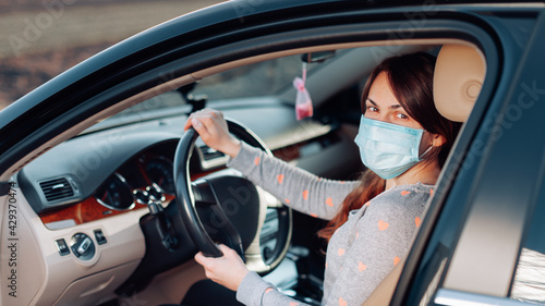 Woman in the medical mask in car. coronavirus, disease, infection, quarantine, covid-19