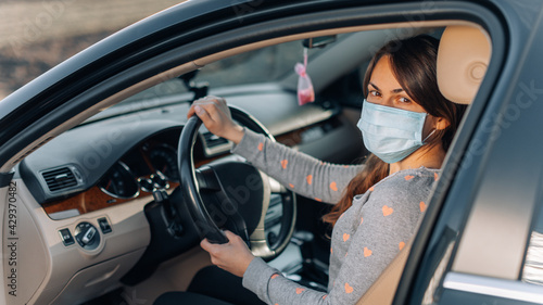 Woman in the medical mask in car. coronavirus, disease, infection, quarantine, covid-19 © Ruslan Ivantsov