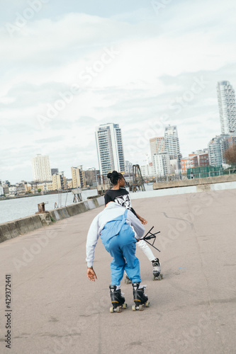 Friends skating by water 