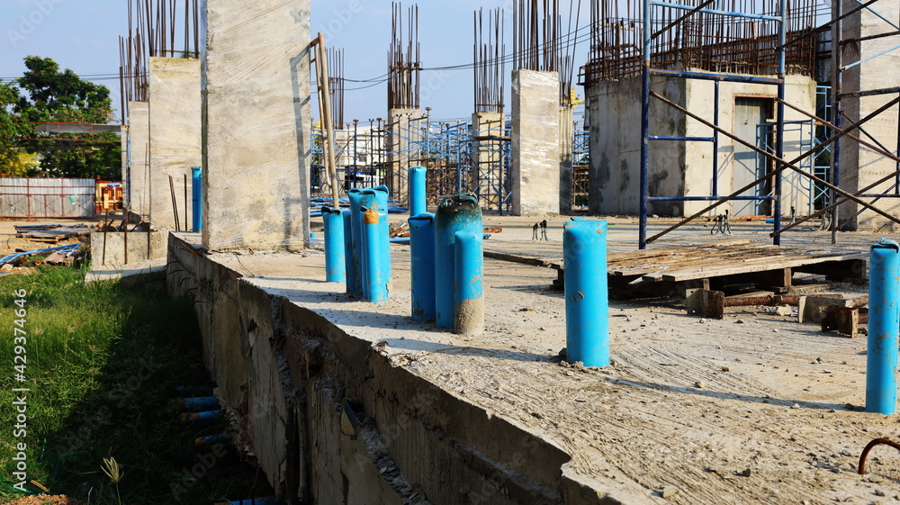 Blue PVC pipes on the building floor. Installation of PVC pipes under concrete floors for sewer systems and toilets of buildings under construction on the background of curing cement columns. Blue PVC pipes on the building floor. Installation of PVC pipes under concrete floors for sewer systems and toilets of buildings under construction on the background of curing cement columns.