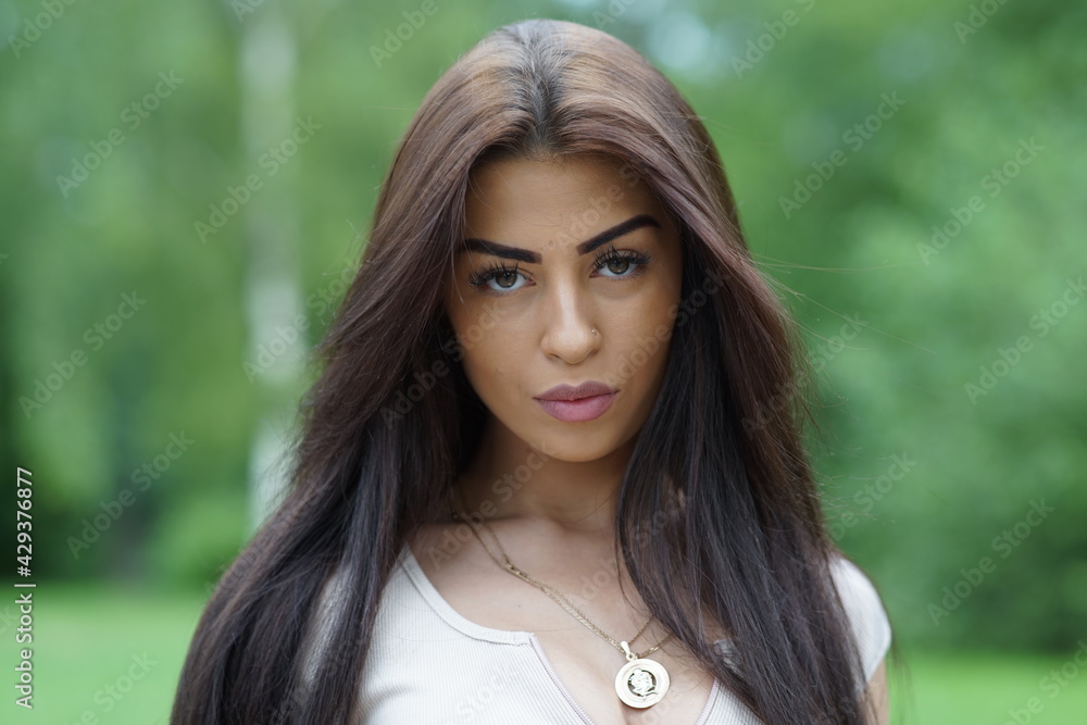 Portrait of a young beautiful girl in the park