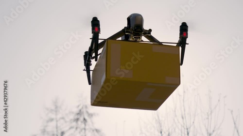 big delivery drone carrying parcel in the sunlight