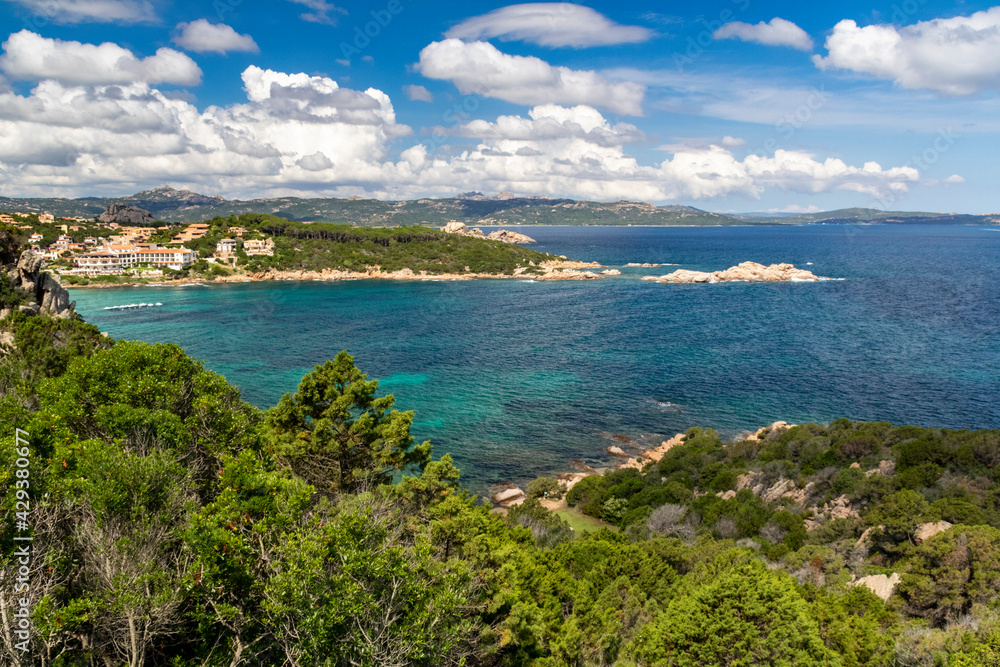Sardinia: Colourful Granite Coastline with Batteria Battistoni Ruins,  Islands of Maddellena and Caprera With Blue Sky – Baia Sardinia, Costa Smerelda, Sardinia, Italy.