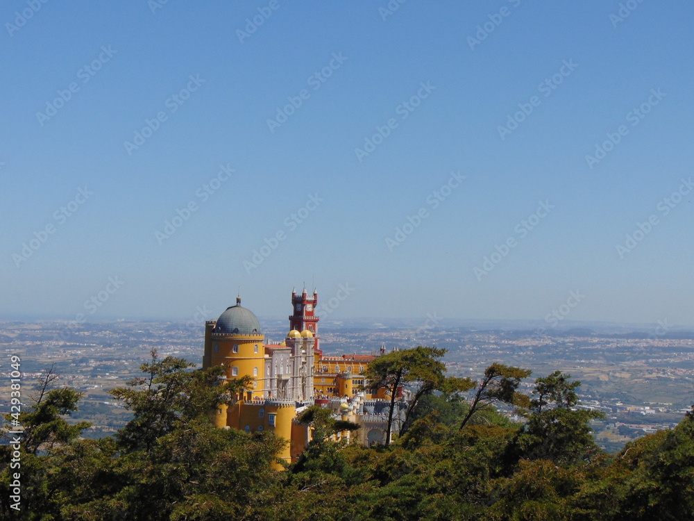 view of the Pena Palace, Sintra, portugal, from the top of the hill, on sunny may day view of the Pena Palace, Sintra, portugal, from the top of the hill, on sunny may day