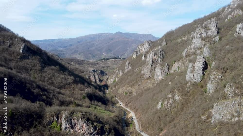 Aerial drone view of valley surrounded by mountains in early spring. Mountain range and canyon. Nature landscape. Aerial drone view of valley surrounded by mountains in early spring. Mountain range and canyon. Nature landscape.