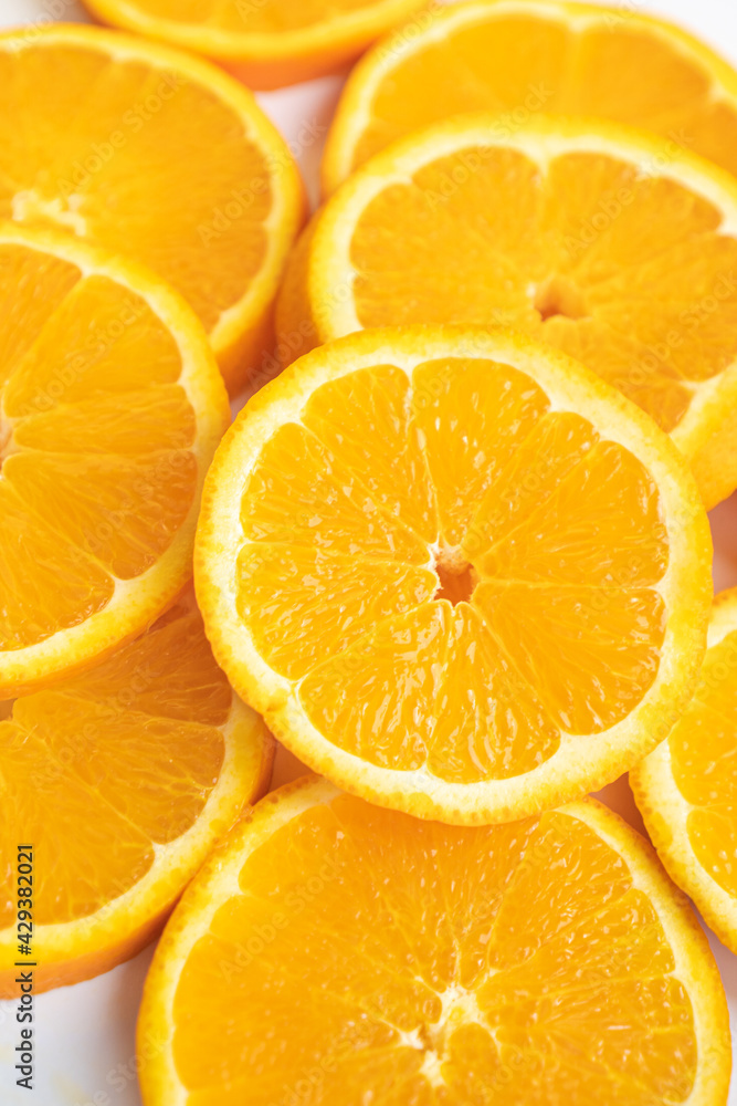 Orange vitamin bomb. Heap of stacked orange slices. Perfectly sliced oranges. Juicy orange pieces. Vertical image Orange vitamin bomb. Heap of stacked orange slices. Perfectly sliced oranges. Juicy orange pieces. Vertical image