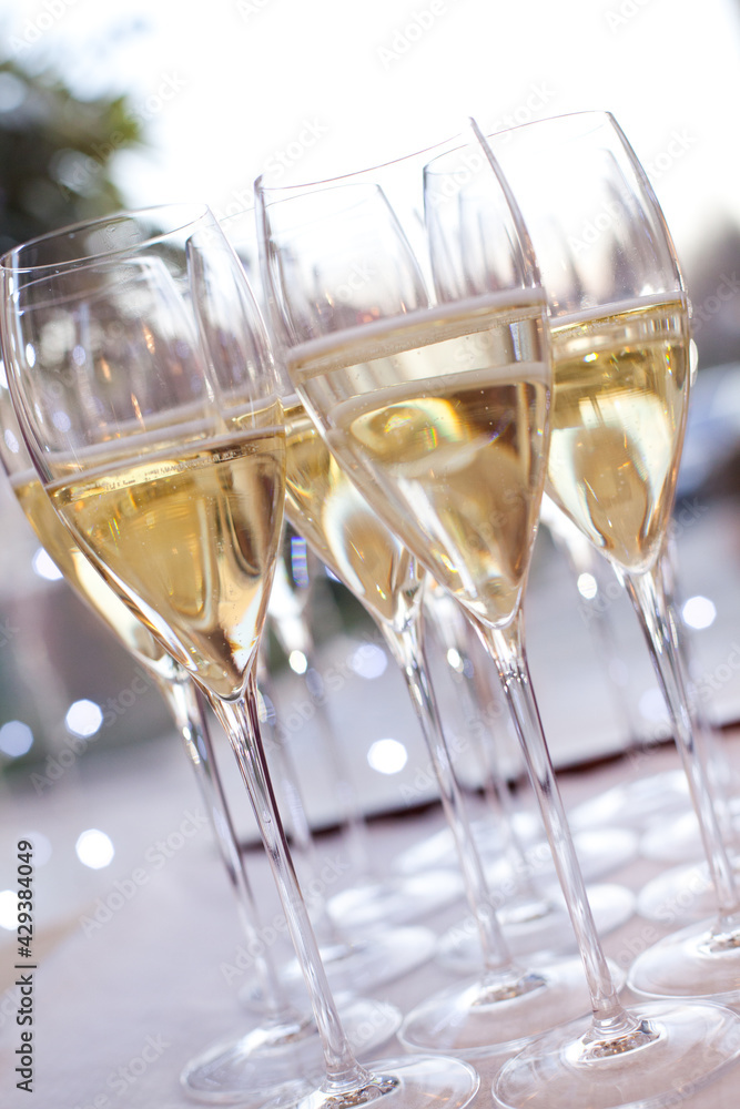 Champagne in bottles and in many glasses Champagne in bottles and in many glasses