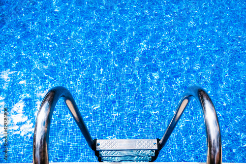 Ladder to go down to a pool with clean and transparent waters, to cool off in summer.
