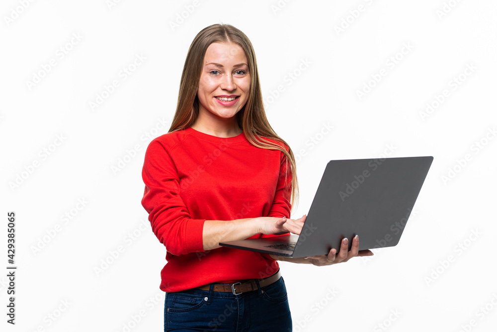 Fototapeta premium young beautiful modern woman having an laptop in hand isolated on white background