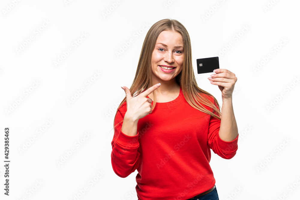 Beautiful woman holding empty credit card and pointing at it isolated on white background Beautiful woman holding empty credit card and pointing at it isolated on white background