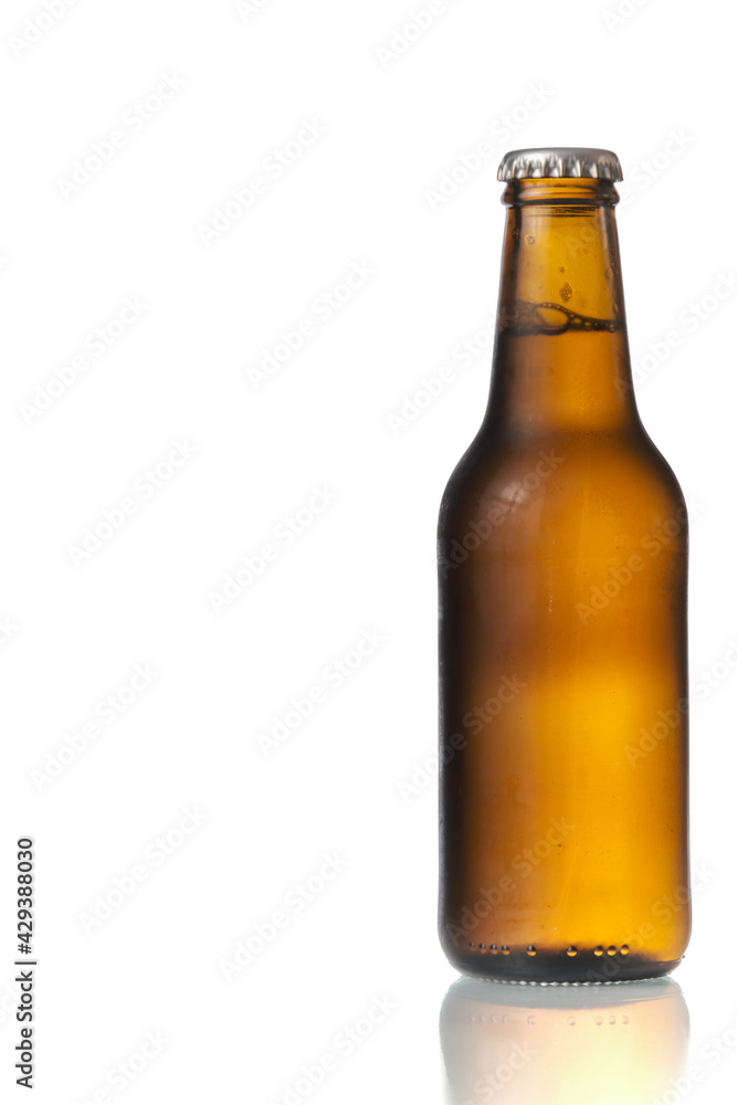 Brown beer bottle in a white background. Beer brown bottle with drops isolated in white background Brown beer bottle in a white background. Beer brown bottle with drops isolated in white background