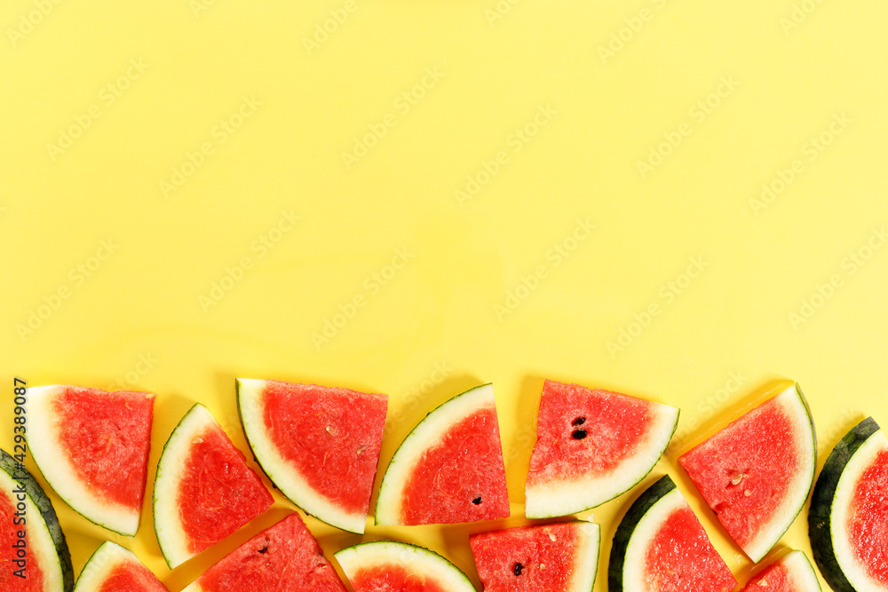 Sliced watermelon on yellow background, top view Sliced watermelon on yellow background, top view