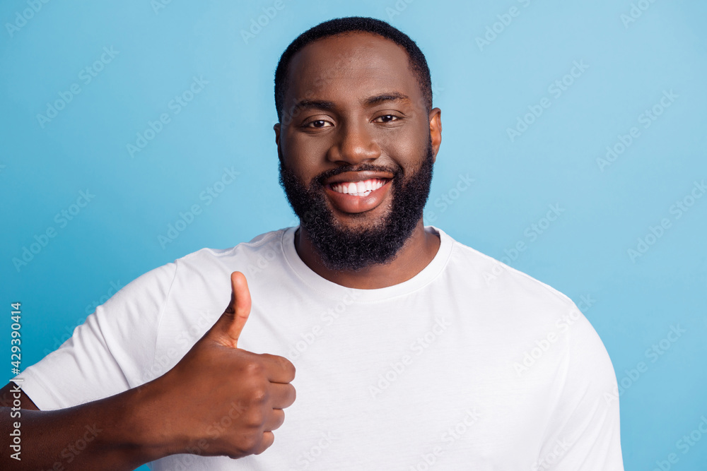 Adviser promoter african man raise thumb up shiny white smile posing on blue background Adviser promoter african man raise thumb up shiny white smile posing on blue background
