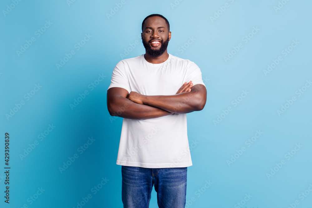 African worker manager standing with arms crossed nice smile on blue background African worker manager standing with arms crossed nice smile on blue background