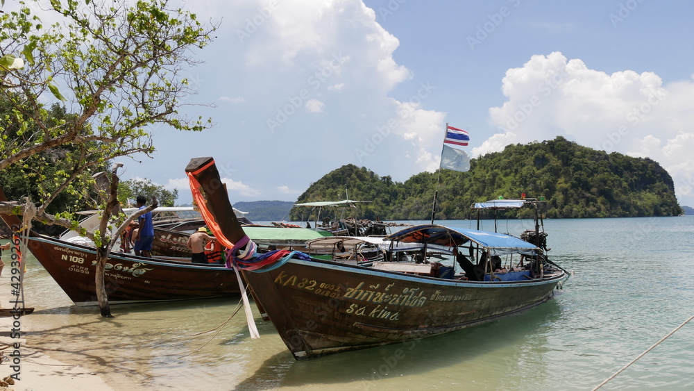 April 14 2021 - Ko Hong, Krabi, Thailand : Tourists  long tail boat with beautiful nature limestone hill at Andaman Sea, Ko Hong, Krabi, Thailand. Famous tourist destination at Krabi.