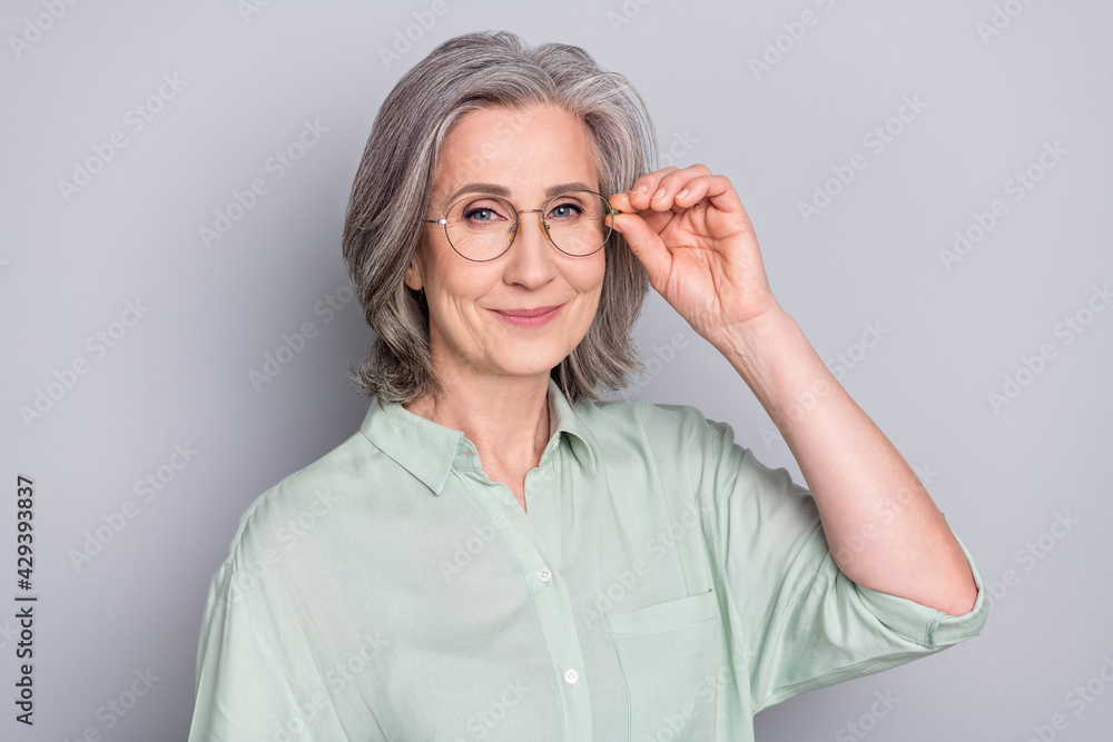 Photo of happy positive smiling beautiful lovely smart businesswoman in glasses isolated on grey color background Photo of happy positive smiling beautiful lovely smart businesswoman in glasses isolated on grey color background
