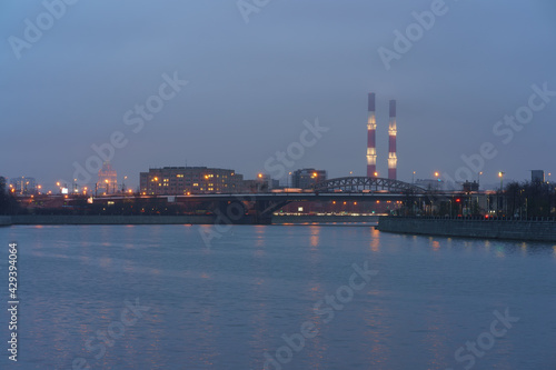 Moscow cityscape and Moscva river in blue colors at evening  spring time. Dull sunset  rain.