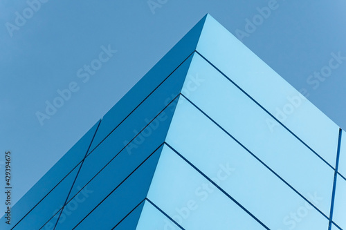 Geometric colored building facade elements with planes  lines and corners with light flare and reflections for an abstract background and texture of white  blue  gray colors. Place for text