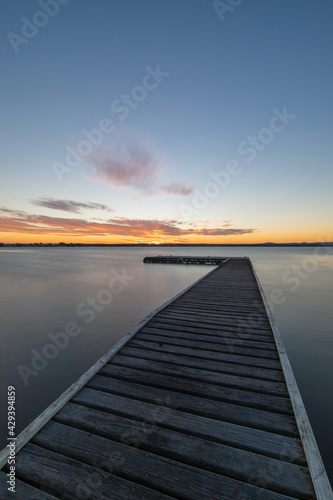 Fototapeta Naklejka Na Ścianę i Meble -  Long exposure view of a pier in the lake.