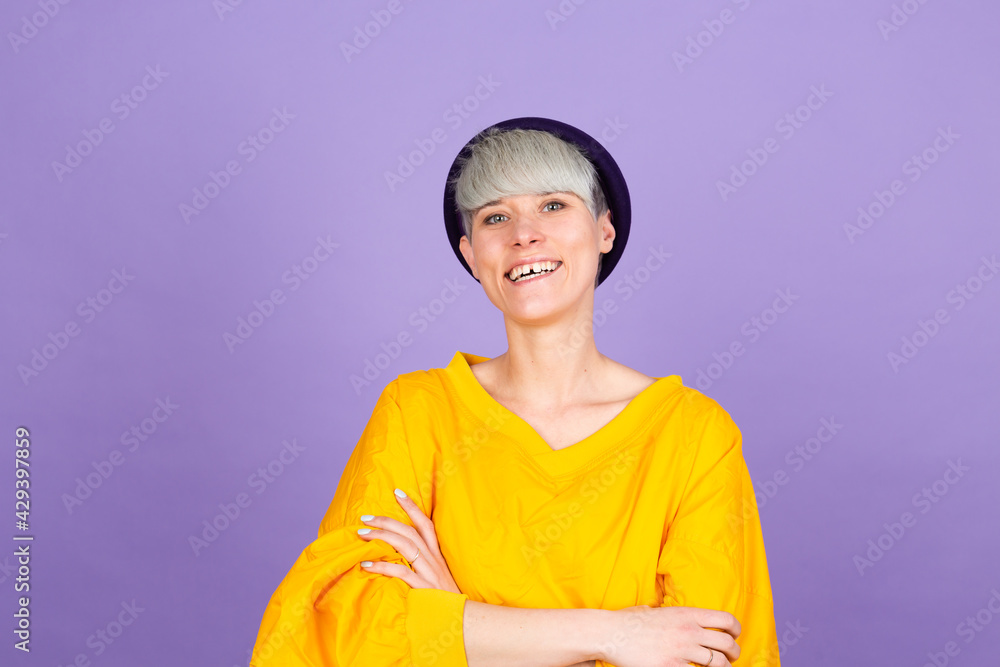 Stylish european woman on purple background happy face smiling with crossed arms looking at the camera. Positive person Stylish european woman on purple background happy face smiling with crossed arms looking at the camera. Positive person