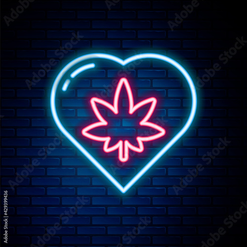 Glowing neon line Marijuana leaf in heart shape icon isolated on brick wall background. Hemp symbol. Colorful outline concept. Vector