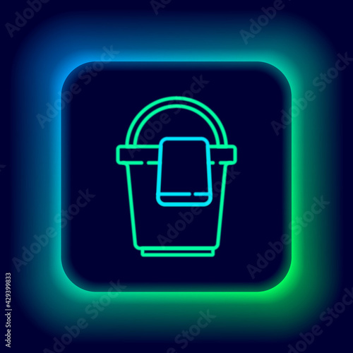 Glowing neon line Bucket with rag icon isolated on black background. Cleaning service concept. Colorful outline concept. Vector