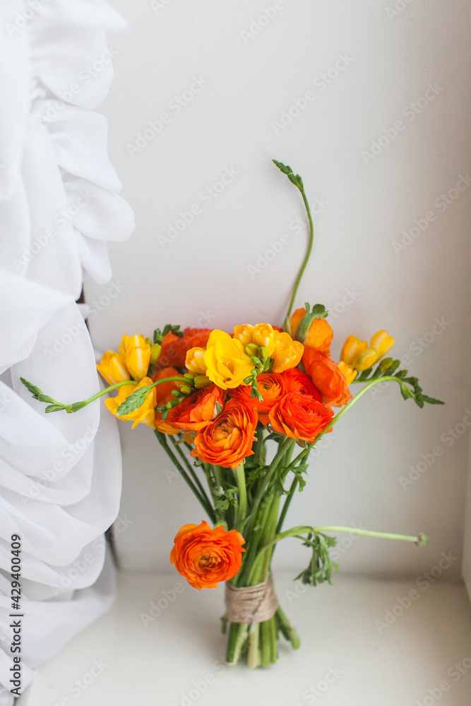 Wedding bouquet made of fresh bunch of orange ranunculus flowers