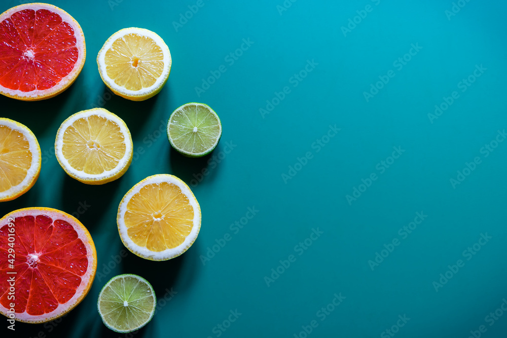 Citrus fruit halves slices on blue turquoise background. Freshly colourful pattern, flat lay, copy space, close-up. Citrus fruit halves slices on blue turquoise background. Freshly colourful pattern, flat lay, copy space, close-up.