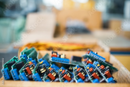 Close-up green embedded microcircuits are stacked in box to prepare for the further in factory for production of equipment