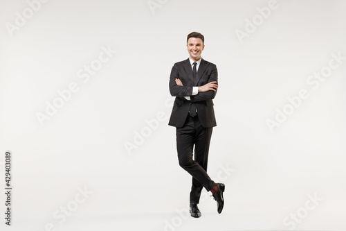 Full length young successful employee business corporate lawyer man 20s wearing classic formal black grey suit shirt tie work in office hold hands crossed folded isolated on white background studio.
