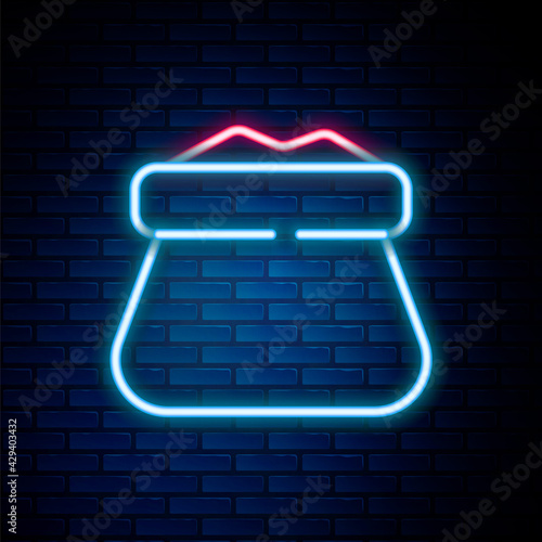 Glowing neon line Full sack icon isolated on brick wall background. Colorful outline concept. Vector