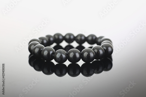 Black bracelet with round identical balls closeup