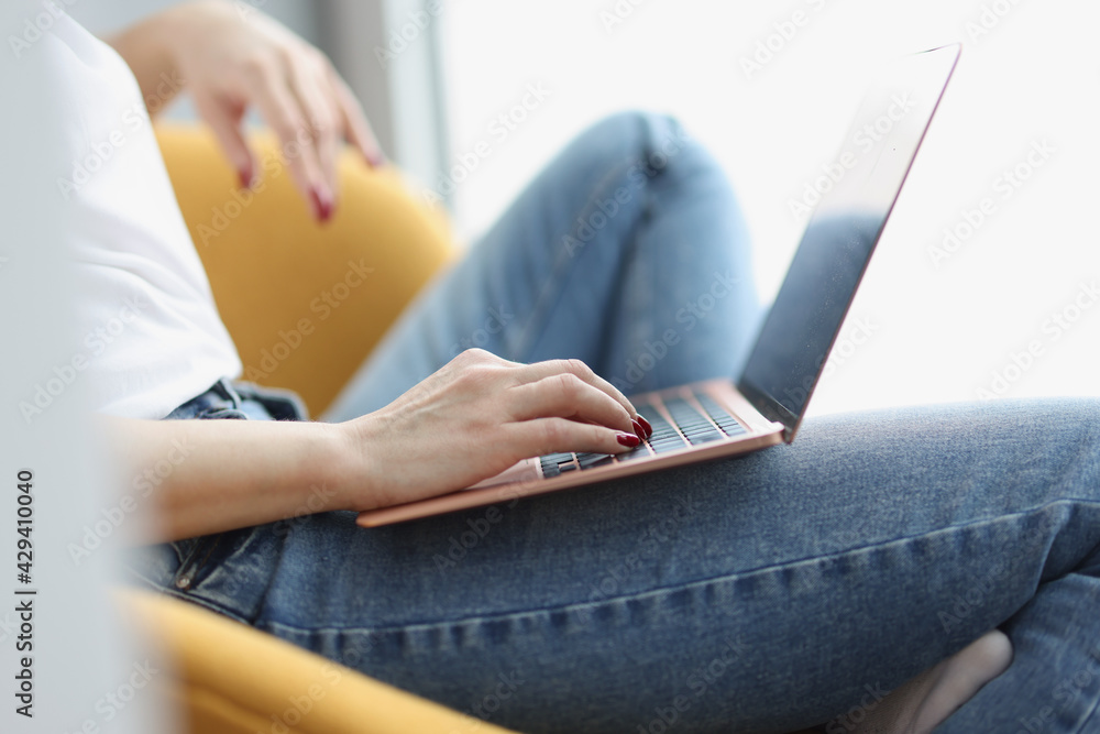 Fototapeta premium Female hands on keyboard on laptop closeup