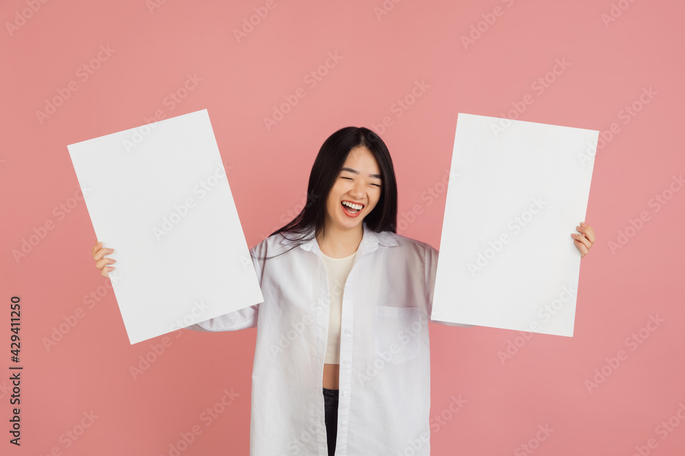 Asian young woman's portrait on pink studio background. Concept of human emotions, facial expression, youth, sales, ad. Asian young woman's portrait on pink studio background. Concept of human emotions, facial expression, youth, sales, ad.
