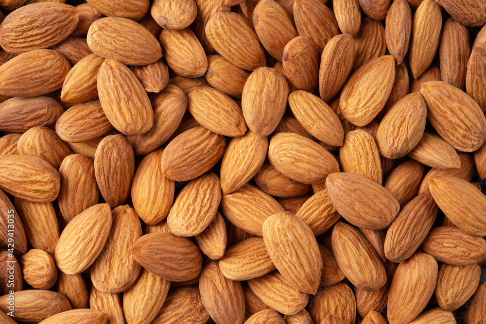 Almond background. Almonds top view background. Whole almond nuts flat lay. Full depth of field. Almond background. Almonds top view background. Whole almond nuts flat lay. Full depth of field.