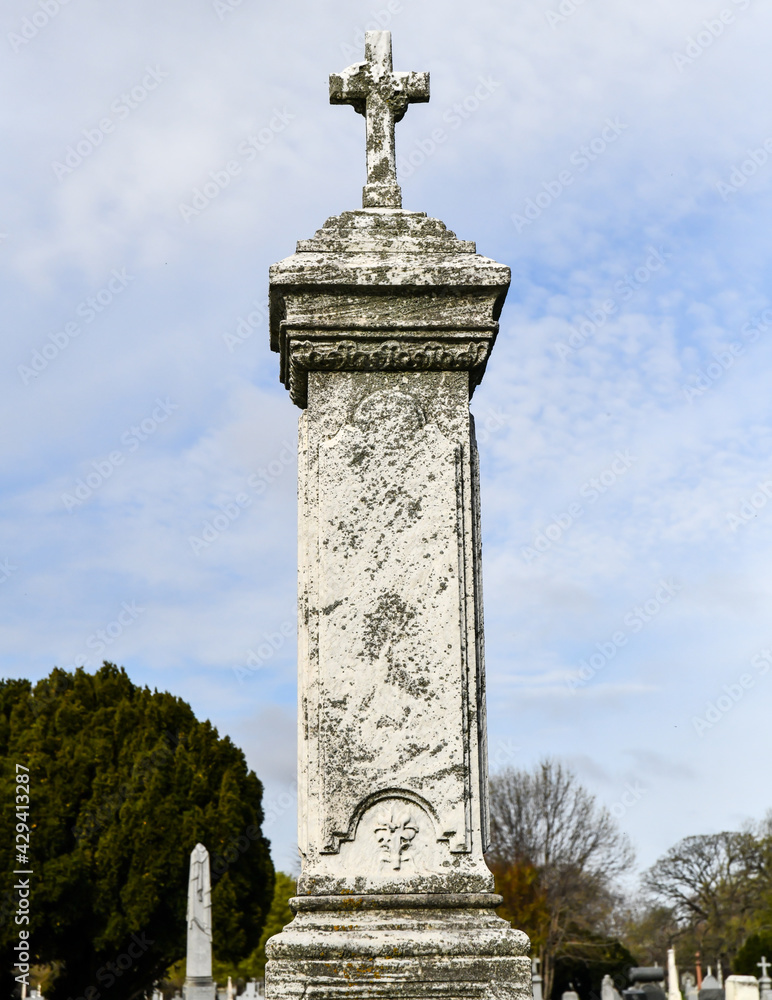 Fototapeta premium Weathered old vintage cemetery tomb and gravestone with moss